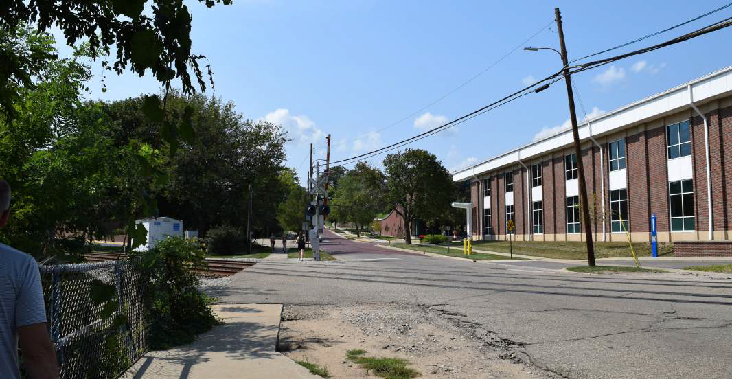 Looking West on Academy street from Stadium Drive, showing railroad tracks and the side of the fitness center
